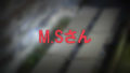 大阪府橿原市のマンションの上から見た駐輪場のモザイク入り写真の中央に赤文字でM.Sさんと書かれた画像です。